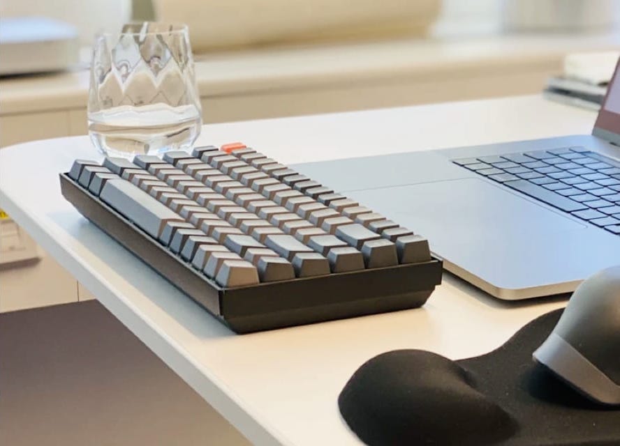 keyboard with glass on a table 